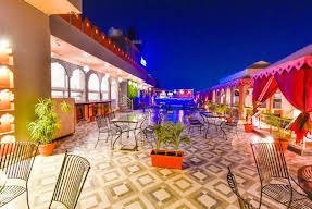 Courtyard restaurant with red drapes at night