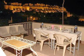 Terrace dining table with illuminated fort view