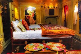 Room with painted mural and red bed