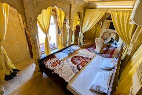 Room with arched windows and yellow curtains