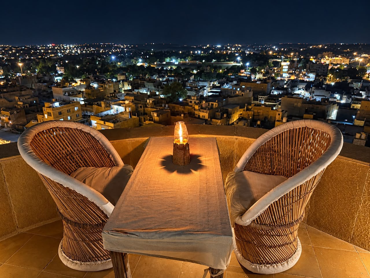 Candlelit terrace table over the city at night