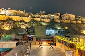 Terrace at night facing the lit fort