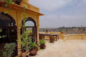 Sunlit terrace with potted plants and arches