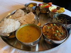 Home-style thali with roti, rice, dal and curries